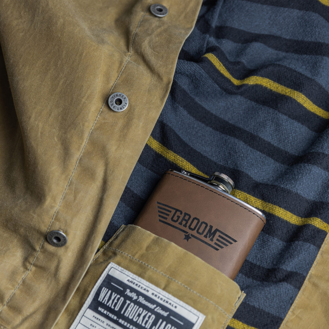 Flasks – Dark brown leather Flask with engraved Groom wings design in the inside pocket of an olive jacket – Lifestyle view